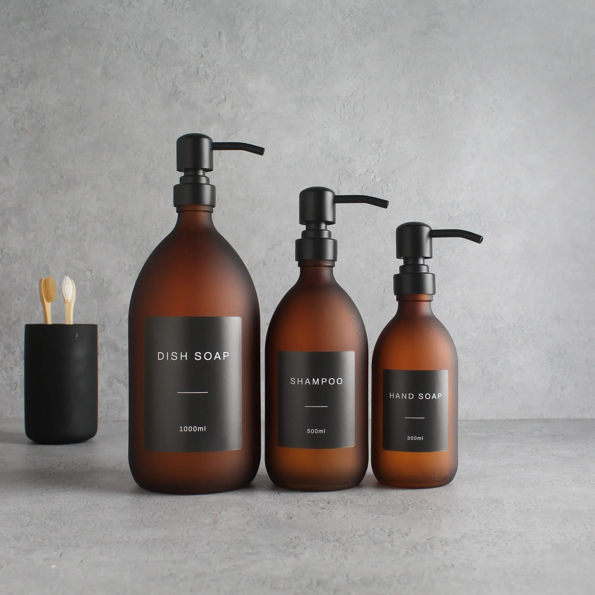 Labelled Frosted Amber Glass Dispenser Bottle With Matte Black Pump - Image 2