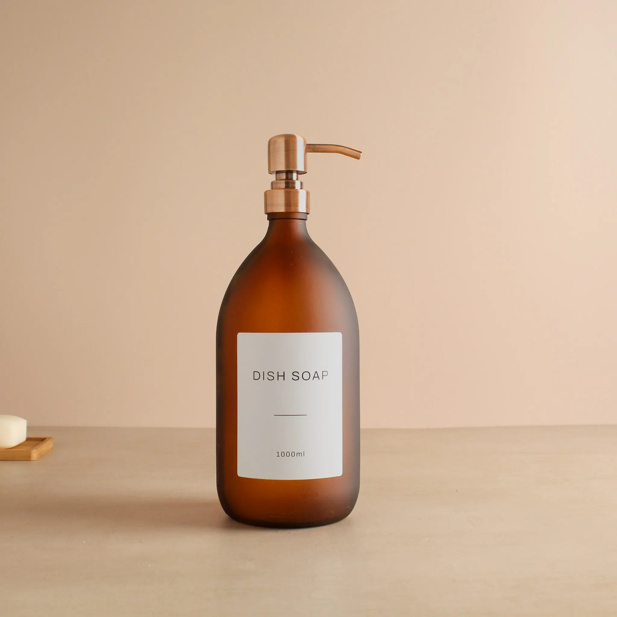 Labelled Frosted Amber Glass Dispenser Bottle With Rose Gold Pump - Image 3