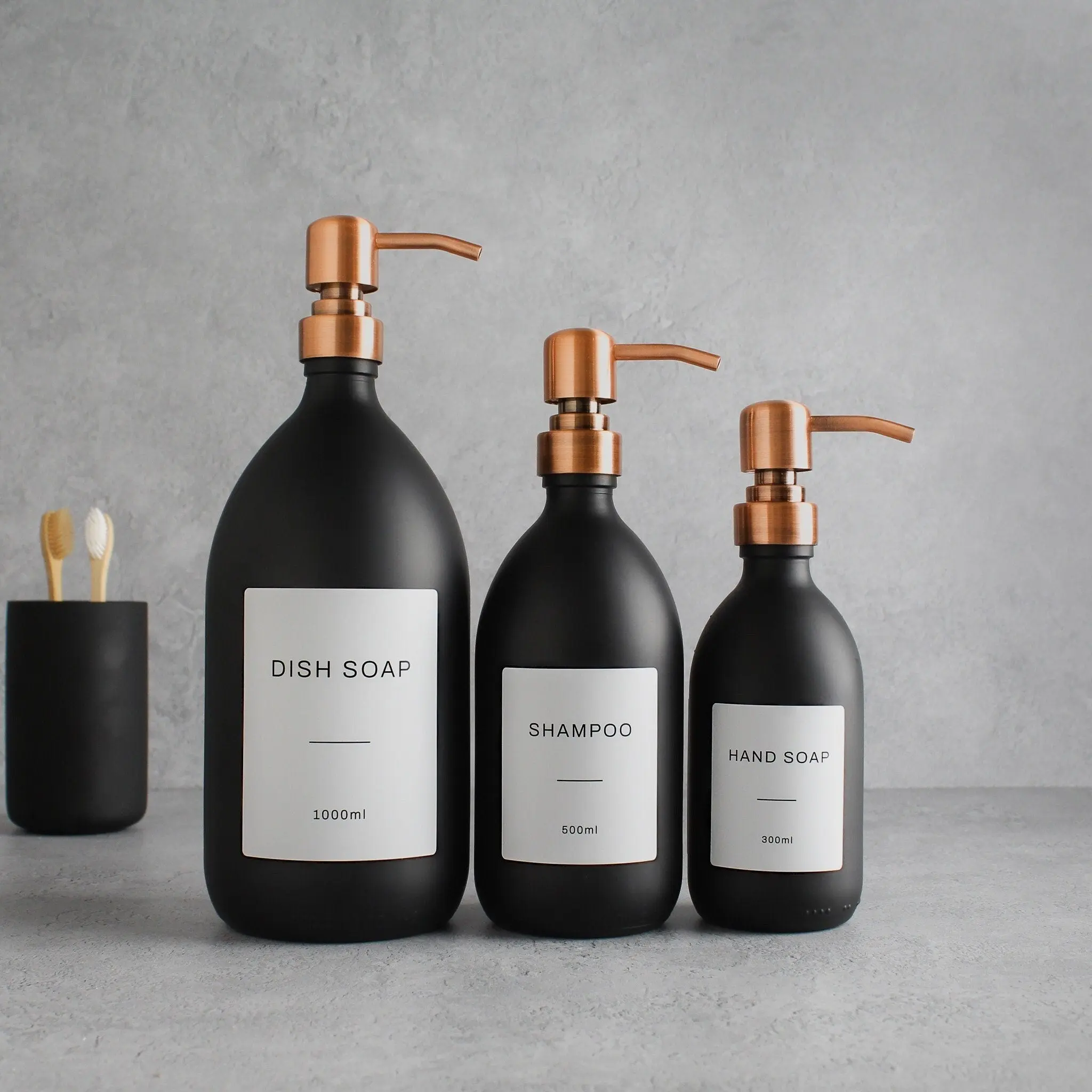 Labelled Matte Black Glass Dispenser Bottle With Rose Gold Pump - Image 2